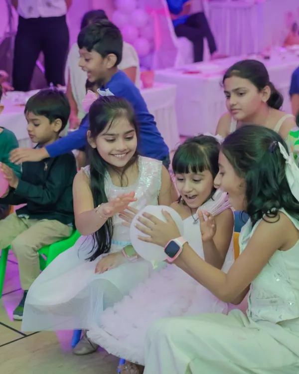 A group of girls sharing a laugh and playing a game together. Capturing these moments of friendship and fun is the best part of my job.