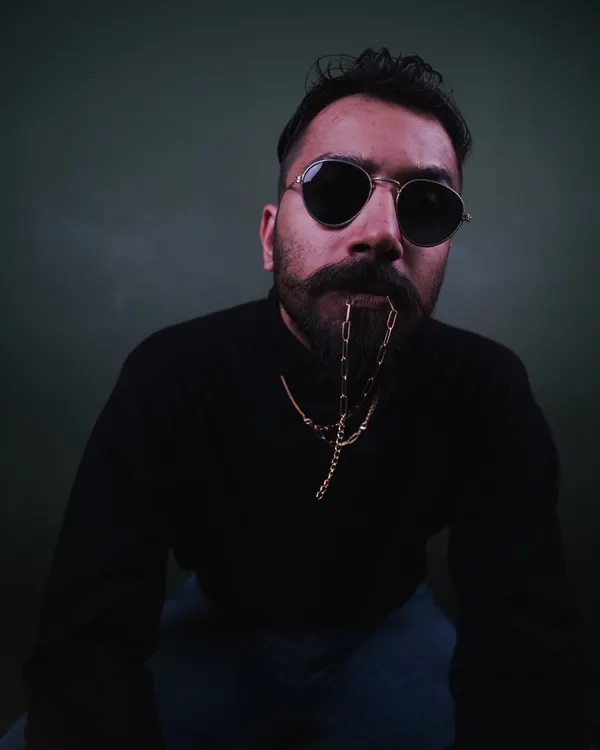 This is my signature look. A moody, close-up portrait that captures the classic, rugged style I bring to men's fashion and accessory photoshoots.