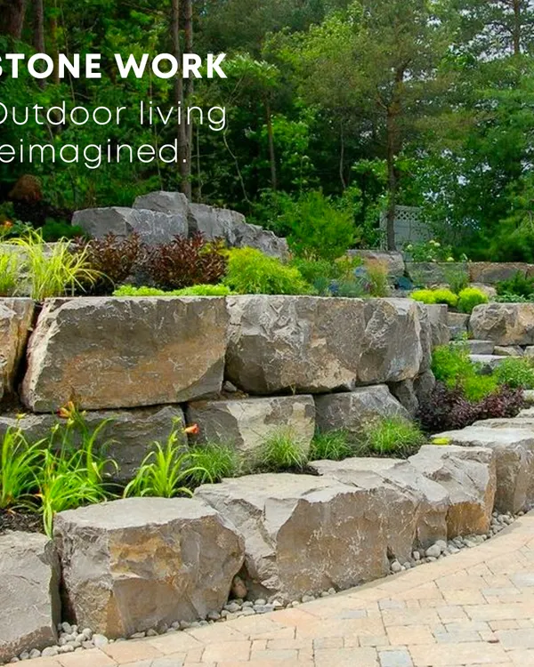 Natural stonework provides a strong foundation for any garden design. Here, large boulders create a multi-level retaining wall, adding a rugged, organic texture that beautifully complements the surrounding plants. We use hardscaping to bring structure and permanence to the landscape.