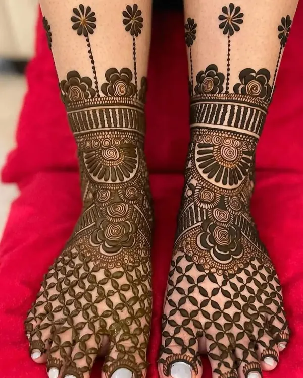 A beautiful full-coverage bridal feet design, featuring a dense floral net pattern on the toes and a delicate floral vine extending up the leg.