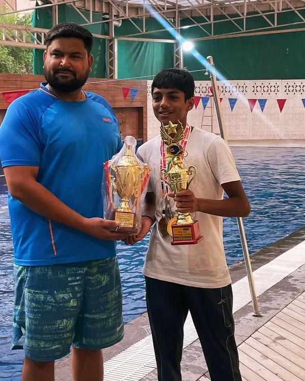 Celebrating another "Best Swimmer of the Meet" title for Aryaman Suri. Here we are poolside with his well earned trophies from the NCR Open Swimming Meet. His consistent victories are a direct result of his dedication and our structured training program.