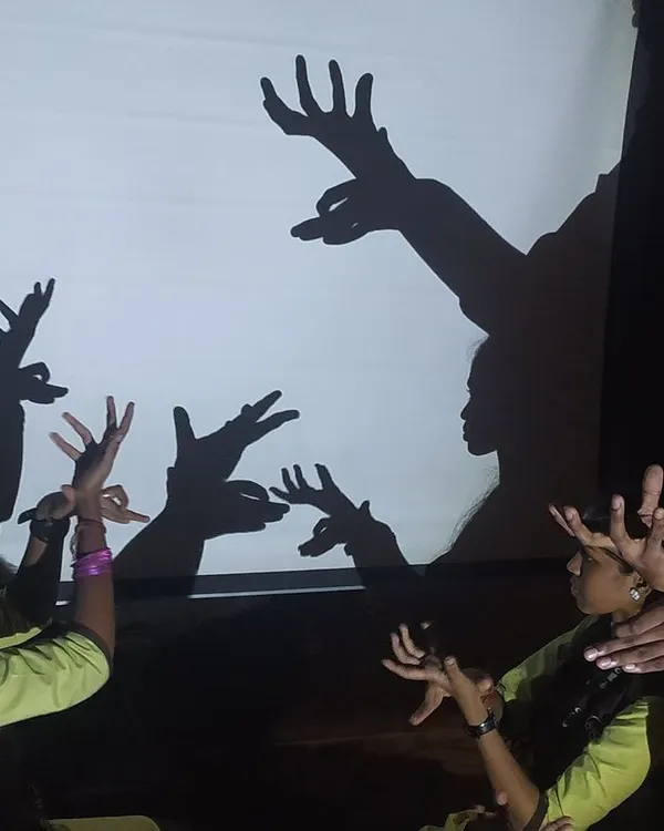 With just our hands and a light, we create entire worlds. Here, you can see multiple hands from our family working together to bring a family of deer to life on the screen.