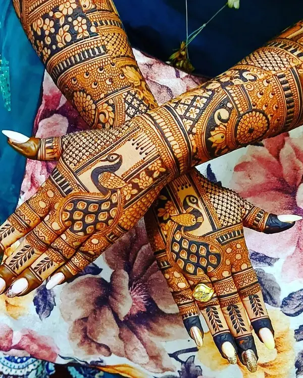 This is a classic back-hand design filled with detail. I've combined intricate peacock motifs with delicate check patterns and floral elements, creating a full and festive look perfect for any celebration.