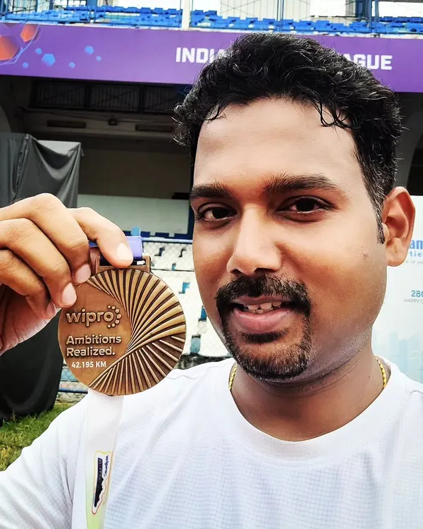 A close up of the prize. This member proudly holding his finisher medal after completing his first full marathon at the Wipro Bengaluru Marathon. A huge achievement made possible through consistent group training.