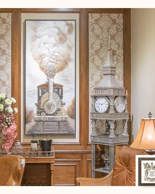 This impressive 3D wall art of a steam engine is a true statement piece. Its textured details and grand scale bring a sense of history and adventure to this room, which also features a Big Ben-style clock.