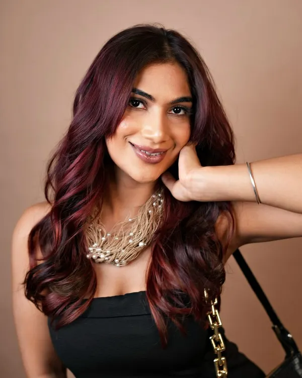 Elegance with a splash of crimson. This vibrant red balayage is a perfect example of our custom color work, creating a bold yet sophisticated statement.