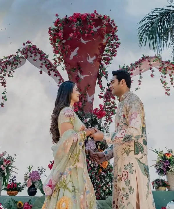 A picture-perfect moment for Shree and Mohnish. They are both wearing custom Rahul Mishra outfits, with his floral kurta perfectly complementing her pastel lehenga.
