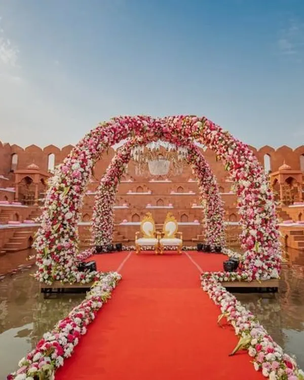 This is the kind of royal wedding dream I bring to life. This stunning venue, just an hour from Mumbai, features a floating mandap on the water, creating a truly magical setting for your vows.