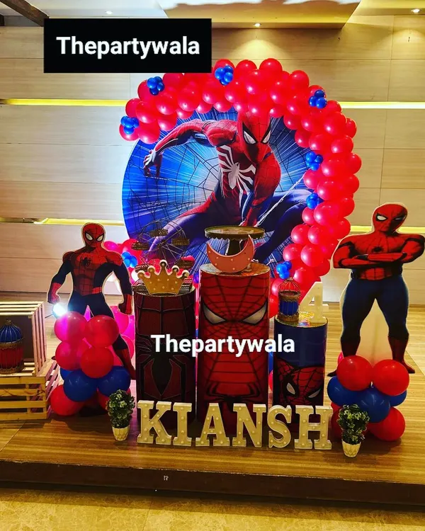 A powerful Spiderman theme for a 4th birthday celebration. The setup features a large character backdrop, themed pedestals, and balloon columns, creating an immersive superhero experience.