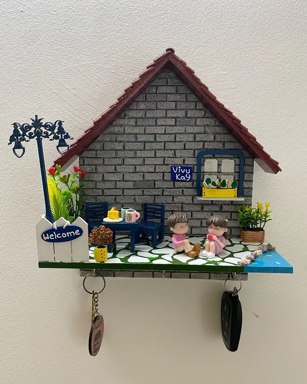 This personalized miniature diorama is my absolute bestseller and also a functional keyholder. I pour my heart into crafting every tiny detail, from the textured brick wall and tiled roof to the little clay figures that represent your family, making it a truly special welcome to your home.