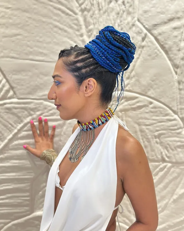 My take on African box braids, using a vibrant blue to create a high-fashion, conceptual bun. This style is perfect for editorial shoots that demand a bold and unforgettable look.