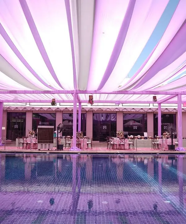 A dreamy poolside Mehendi setup. We used flowing drapes in shades of lilac, lavender, and white to create a soft, ethereal canopy over the entire area, reflecting beautifully in the water.