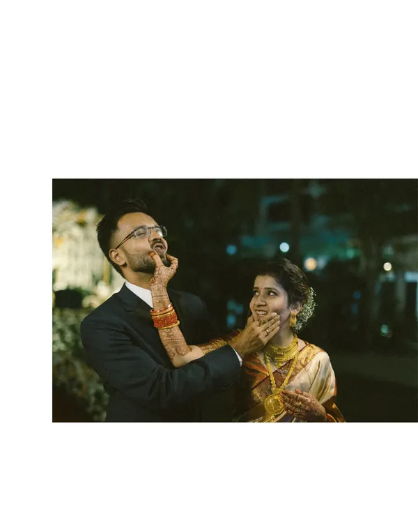 A playful moment during the reception where the bride lovingly smudges cake on the groom's face. It’s these candid, fun-filled interactions that perfectly capture a couple's chemistry and the relaxed joy of the celebration.