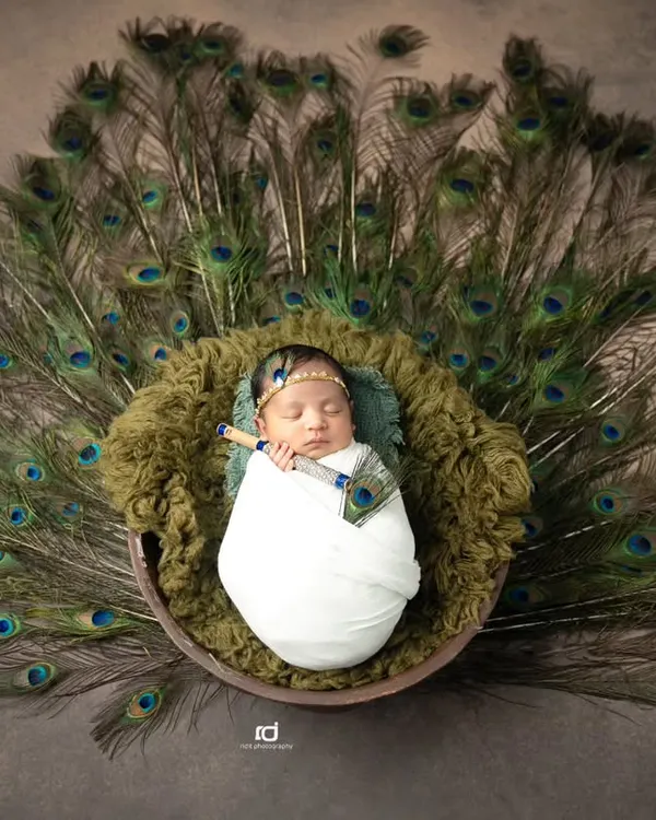 This little one, so peaceful and serene, reminded me of a tiny Krishna. I used soft wraps and a fan of peacock feathers to create this beautiful, divine look for his newborn session.
