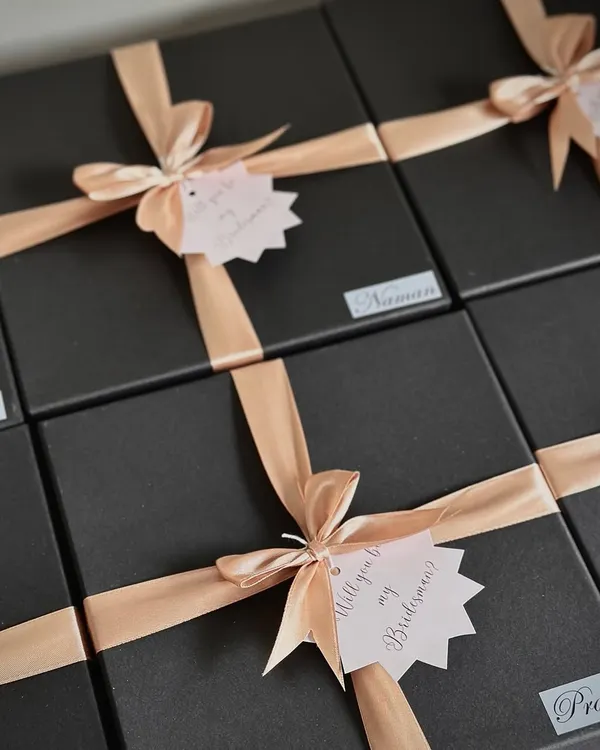 "Will you be my Bridesman?" These sleek black boxes with peach ribbons are perfect for asking the special guys in your life to be part of your wedding day.