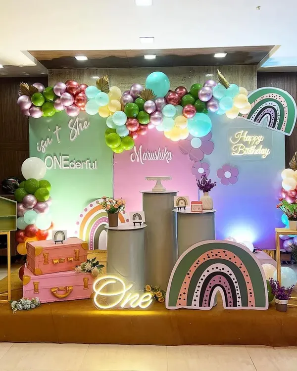 A "ONEDERFUL" first birthday featuring a trendy boho rainbow theme. I used a muted color palette with custom rainbow props, pampas grass, and a neon sign to create a stylish and sweet celebration.
