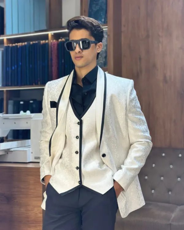 A perfectly tailored three piece tuxedo is not just an outfit, it's a statement. I crafted this white textured tuxedo with a contrasting black waistcoat and lapels for a sharp, modern look that stands out at any high profile event.