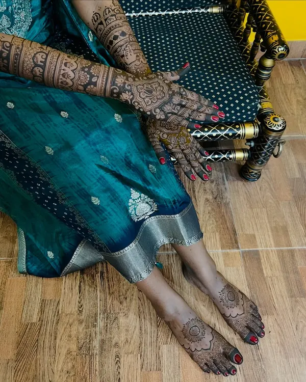 A full bridal look with intricate mehendi on both hands and feet, perfect for the bride who wants complete adornment.