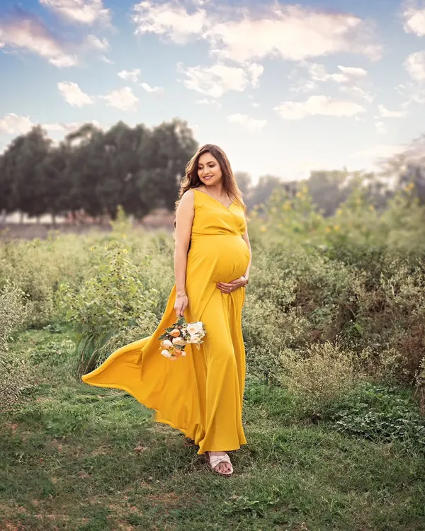 A moment of pure elegance and timeless beauty captured on a serene Bangalore evening. The warm, golden glow caresses the expecting mom-to-be, creating an unforgettable story.