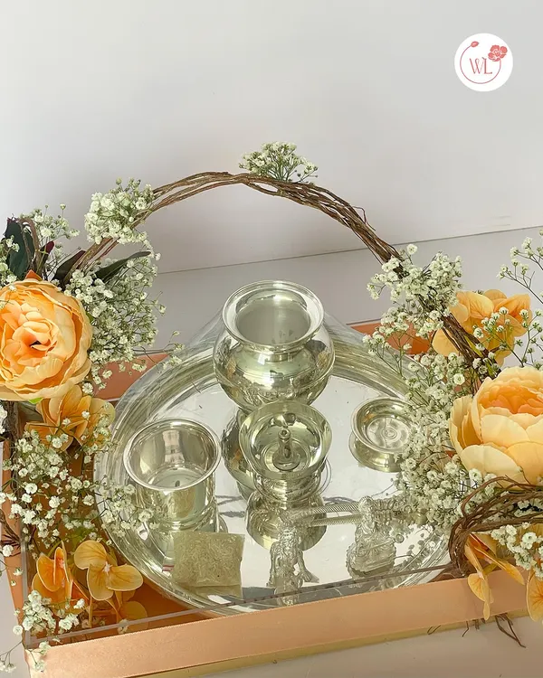 A detailed view of the silver items from my traditional hamper. This set includes a silver-plated lota, glass, and diya, which are not just beautiful but also hold cultural significance, making them a very thoughtful gift.