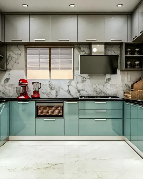 A U-shaped modular kitchen in a striking teal and grey combination. This layout maximizes counter space and storage, featuring a marble-patterned backsplash and integrated appliances for a seamless finish.