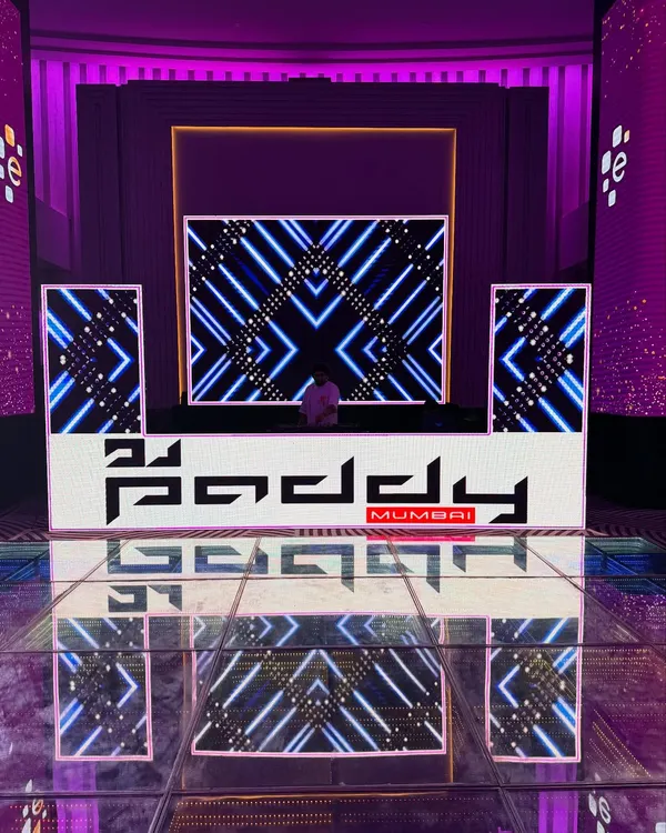 This is what a full-scale production looks like. I bring in custom-branded DJ consoles, massive LED screens for visuals, and a vibrant LED dance floor to create an immersive party atmosphere for your corporate event or sangeet.