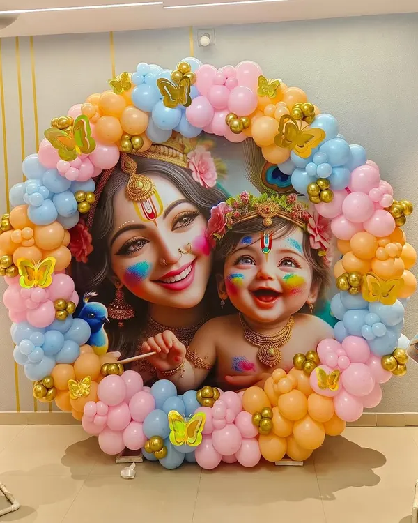This Krishna-themed baby shower was a divine celebration. I created a circular backdrop featuring a beautiful illustration of Yashoda and Krishna, framed by a vibrant garland of pastel pink, blue, and orange balloons with golden butterfly accents. It was a unique and blessed event for the mom-to-be.