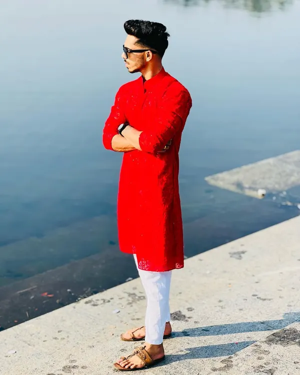 This client is wearing a vibrant red kurta with all-over Chikankari work. I tailored it for a slim fit and paired it with white pajamas for a sharp, festive look.