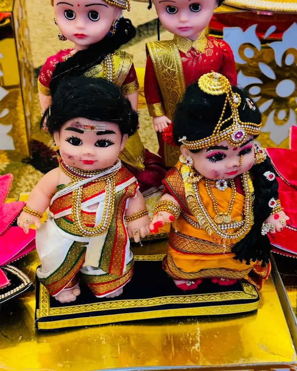 A close-up of my adorable couple dolls, dressed in traditional South Indian attire for a wedding ceremony. The detailing on their clothes and jewelry is what makes them so special.