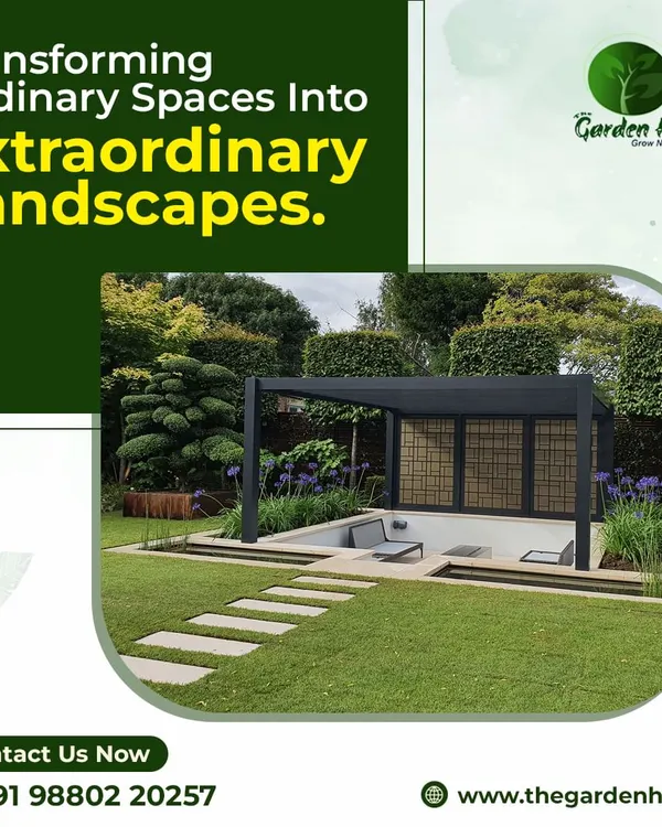 This image showcases a modern, minimalist black pergola set within a manicured landscape. The clean lines and open design create a sophisticated focal point while defining a comfortable outdoor seating area.