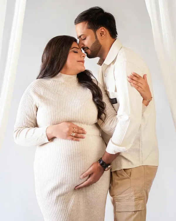 A tender moment between partners, captured in soft, neutral tones for a timeless feel. This is what celebrating your journey together looks like.