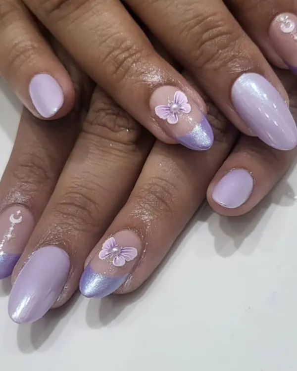 A whimsical and dreamy design. This set features a lavender French tip, pearlescent polish, and delicate, hand-sculpted 3D butterflies and moon charms.