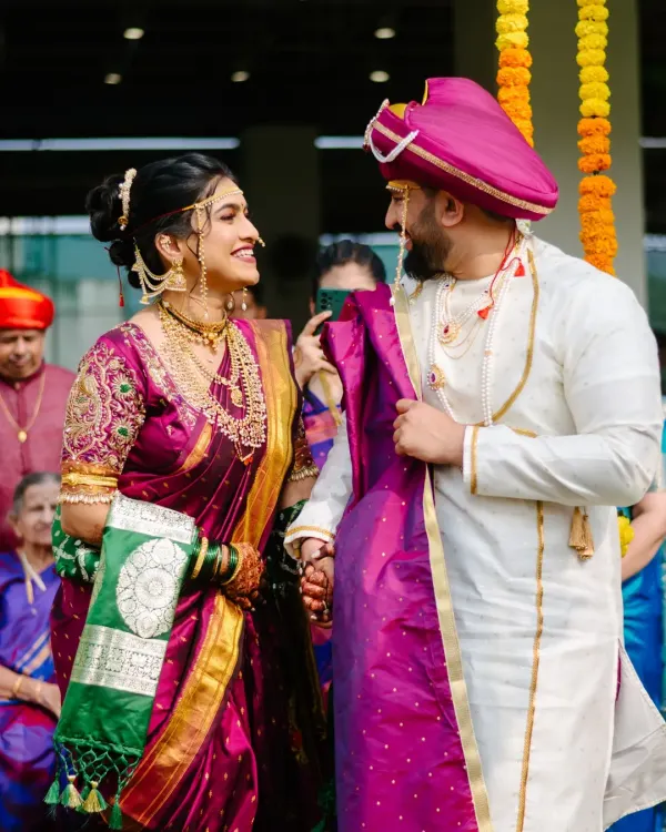 A candid glance between the bride and groom during their Maharashtrian wedding ceremony. These unscripted interactions are the heart of your wedding story.