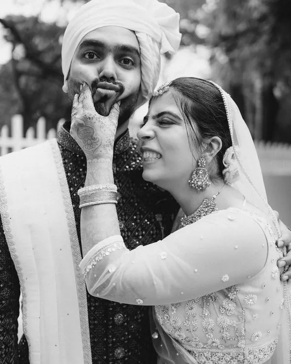 I love capturing these silly, playful moments. Her joyful expression as she squishes his face is pure, unscripted fun, and it tells you so much about their relationship.