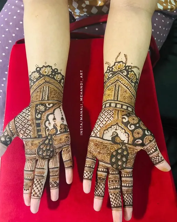 This is one of my favorite designs, featuring detailed peacock and jharokha architecture motifs. It's a perfect example of the rich, full-hand mehandi I create for wedding guests and family members who want an elaborate look.