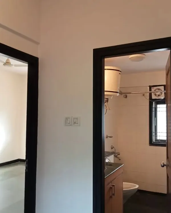 A close-up of a doorway where the wooden frame has been painted black. This high-contrast look adds a sharp, architectural detail to the space.