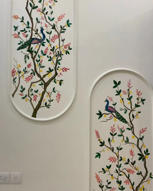 A full view of the peacock and lemon tree mural painted within two arched frames. This design brings a touch of nature and traditional elegance to a modern home.