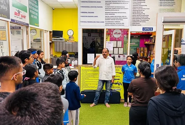 I am addressing a group of young shooters before a competition. A coach's role is not just to teach technique, but to build the confidence needed to perform under pressure.