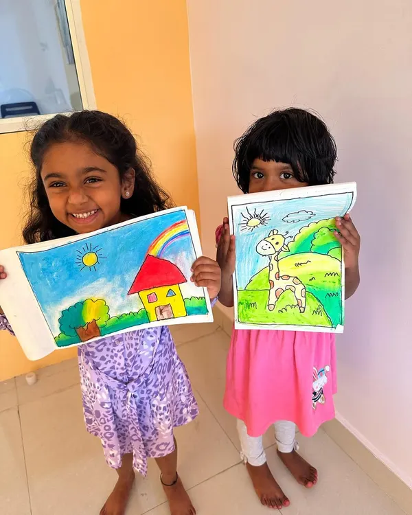 It just warms my heart to see these happy faces. Art is all about joy, and these two little artists are shining so brightly with their colorful creations.