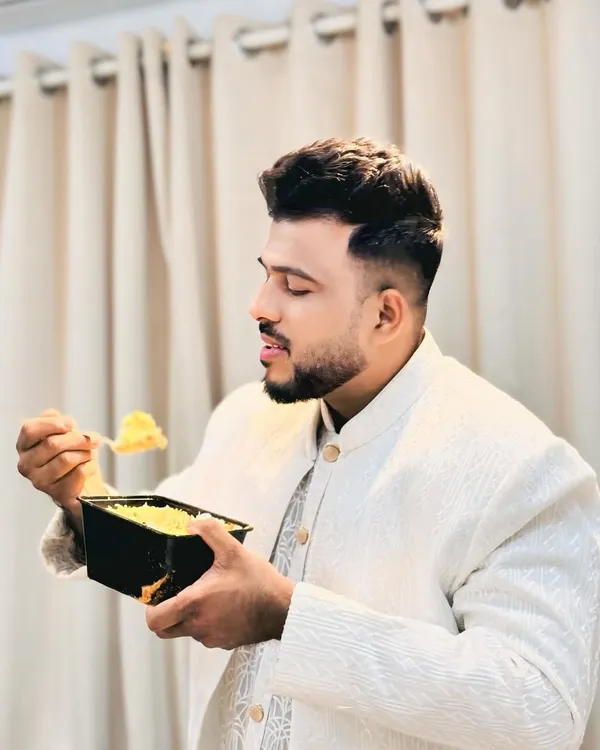A true biryani lover enjoying our special Chicken White Biryani. It's a more delicate and fragrant version of the classic dish.