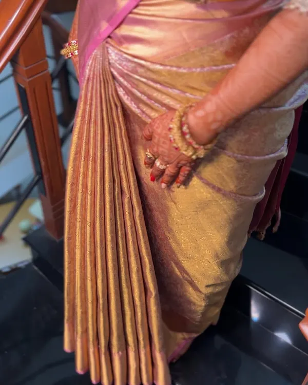 This is my obsession: creating the perfect set of pleats. Notice how each fold is identical in width, creating a beautiful, even cascade on this heavy silk saree.
