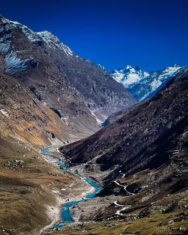 The raw, untamed beauty of Spiti Valley. I used my iPhone for this shot to capture the dramatic contrast between the bright blue river carving its path through the cold, desolate mountain landscape.