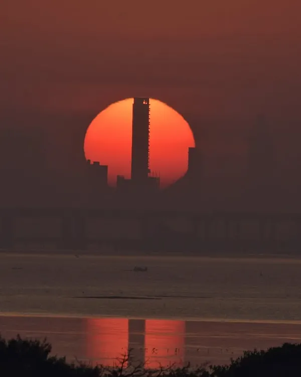 A different kind of Mumbai sunset. I love finding these unique compositions where the setting sun perfectly aligns with the city's architecture, creating a powerful silhouette.