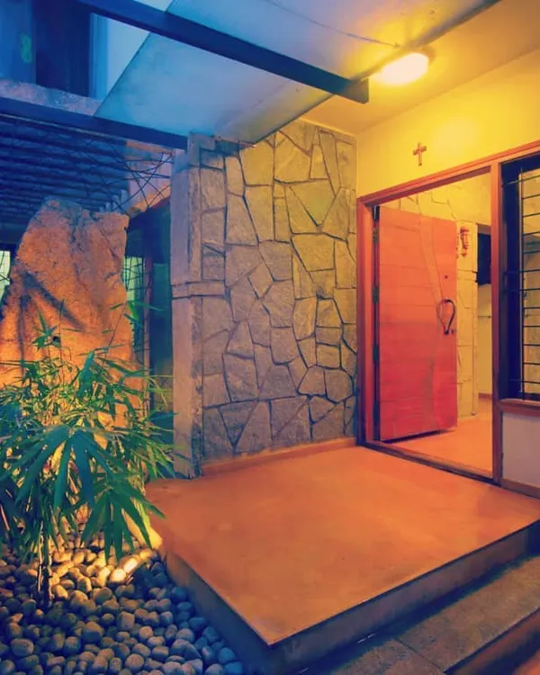 The entrance to a private residence, designed to be a tranquil transition from the outside world. I used natural stone, warm lighting, and integrated planters to create a welcoming and organic entryway.