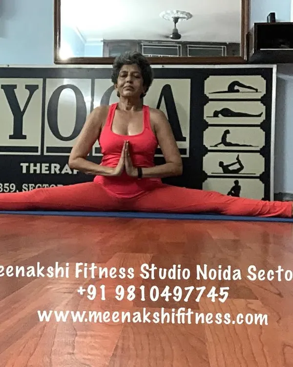 The full front split, or Samakonasana, with hands in prayer. This pose is the result of patient practice, focusing on opening the hips and building strength.
