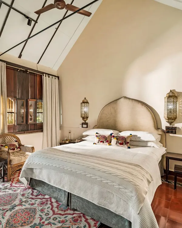 Welcome to Ambara Mana, a 73-year-old Kerala heritage cottage. This spacious room features a high-vaulted ceiling, traditional wooden walls, and elegant furnishings, creating a naturally cool and serene retreat for our guests.