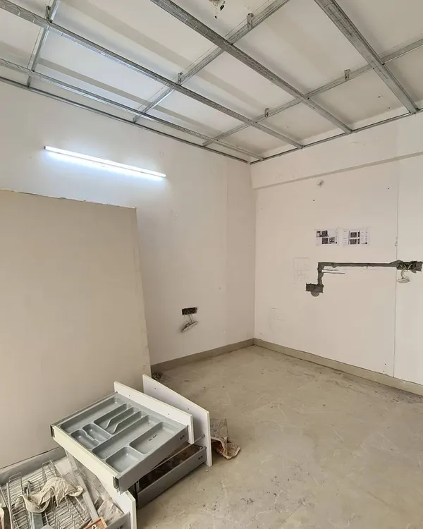 **BEFORE:** The media room in the 'Breeze Home' was an empty space with a basic ceiling structure, a blank canvas for a complete transformation.