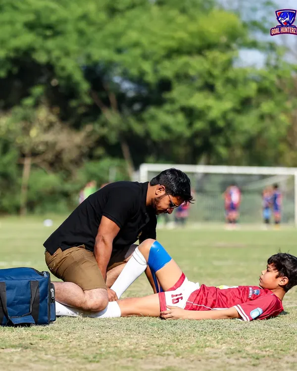 Player safety is our top priority. Our first aid team attending to a young player on the field.