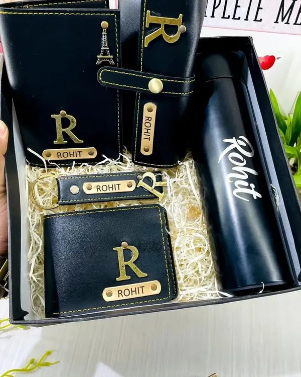 This is my premium leather hamper, an ideal all-in-one corporate gift set. It includes a personalized temperature bottle, a men's wallet, a passport cover, a sunglass holder, and a matching keychain, all made from high-quality black faux leather with custom name and initial engraving.