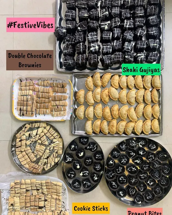A festive dessert platter for Raksha Bandhan, featuring Double Chocolate Brownies, Shahi Gujiyas, Cookie Sticks, and Peanut Bites.